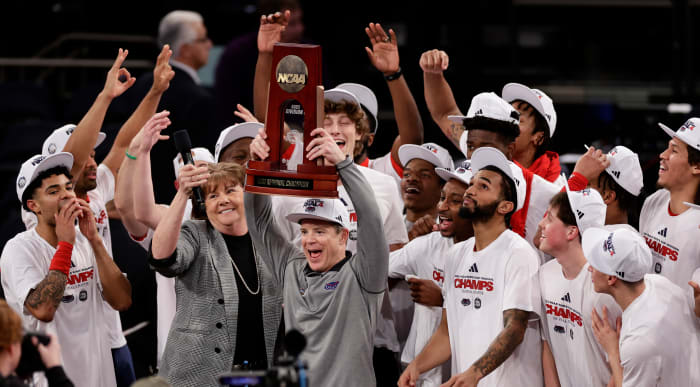 Florida Atlantic head coach Dusty May holds up the East Regional championship trophy after defeating Kansas State in the Elite 8